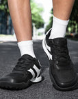 Dannto Mesh Wide - Toe Barefoot Shoes black shown being worn while standing outdoors