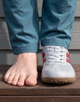 Dannto Frond - Non-Slip Zero Drop Barefoot Sneakers light gray shown on one foot beside a bare foot to demonstrate the wide toe box