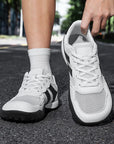 Dannto Mesh Wide - Toe Barefoot Shoes white shown being put on outdoors