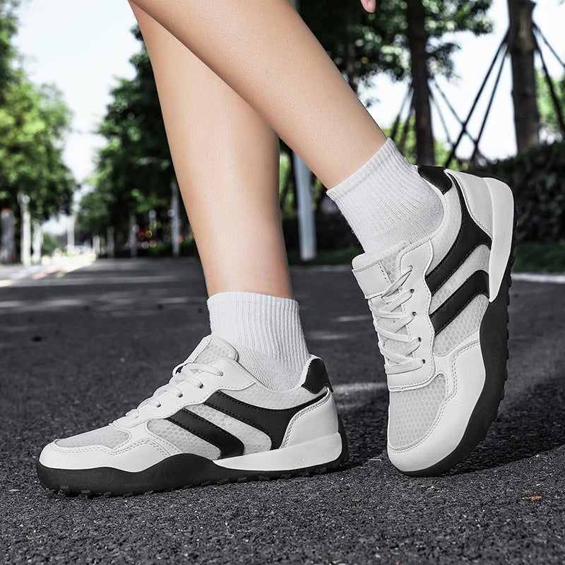 Dannto Mesh Wide - Toe Barefoot Shoes white shown being worn with legs crossed outdoors