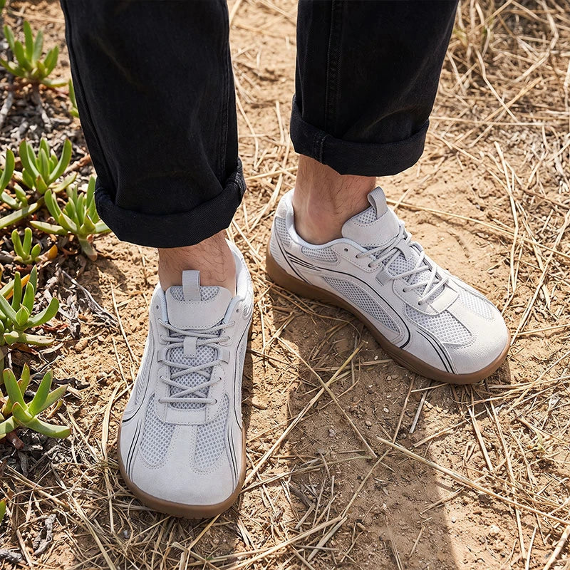 Dannto Aero N1 - 3E Wide Mesh Barefoot Shoes white pair shown from above on grass and rocks