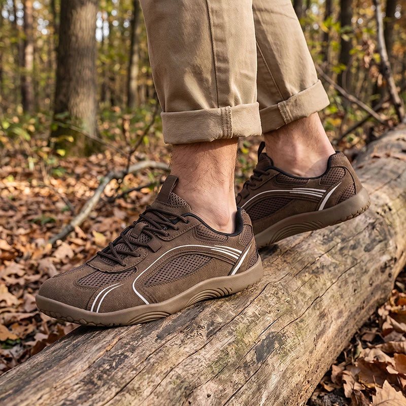 Dannto Aero N1 - 3E Wide Mesh Barefoot Shoes brown shown being worn while walking over tree roots outdoors