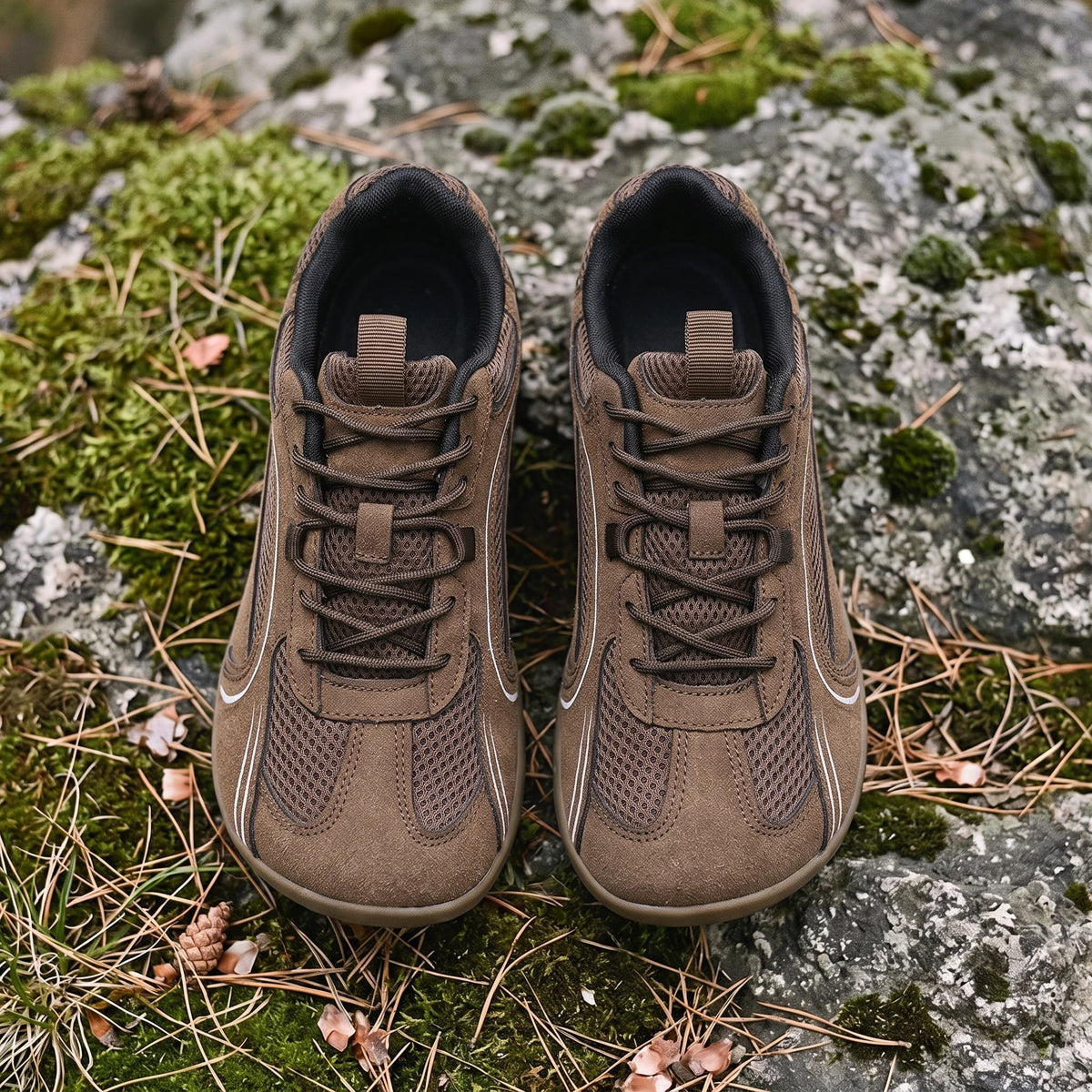 Dannto Aero N1 - 3E Wide Mesh Barefoot Shoes brown pair shown from above on grass and rocks
