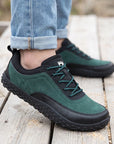 Dannto Aero N4 - 3E Wide Barefoot Shoes green shown being worn while standing on a wooden deck outdoors