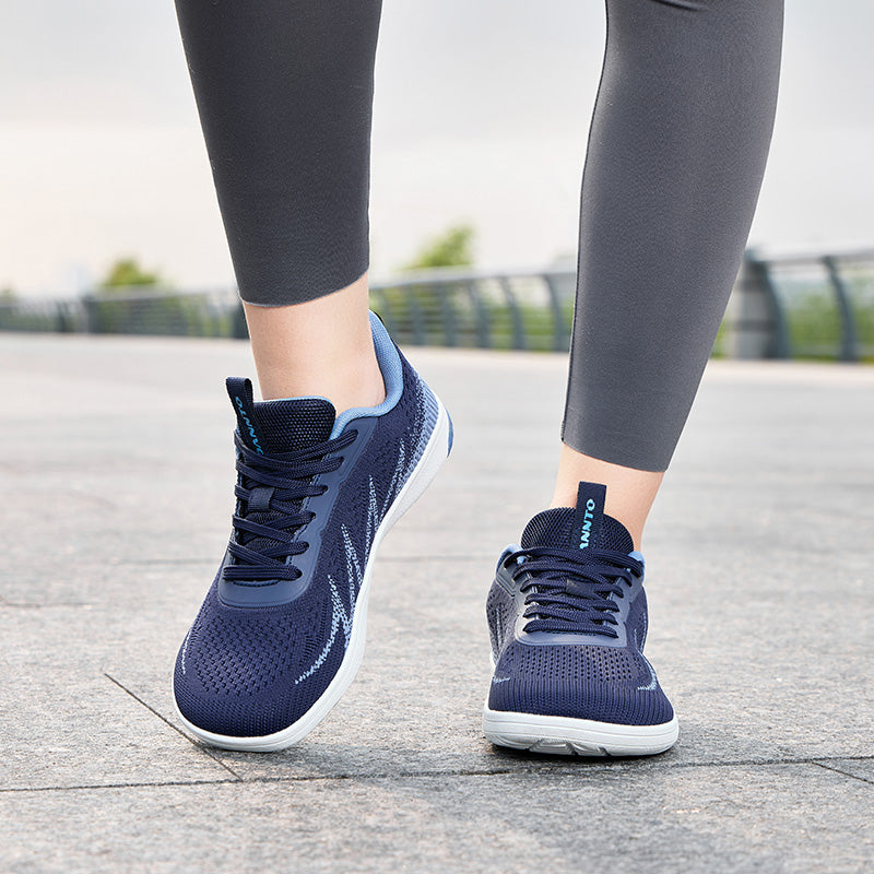 Woman walking outdoors in navy blue Terra B3 wide toe box barefoot shoes