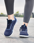 Woman walking outdoors in navy blue Terra B3 wide toe box barefoot shoes