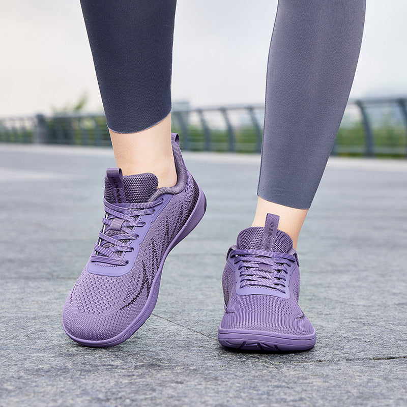 Woman walking outdoors in purple Terra B3 wide toe box barefoot shoes