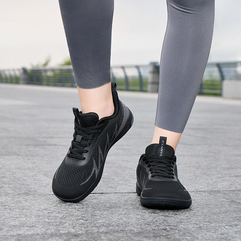 Woman walking outdoors in black Terra B3 wide toe box barefoot shoes