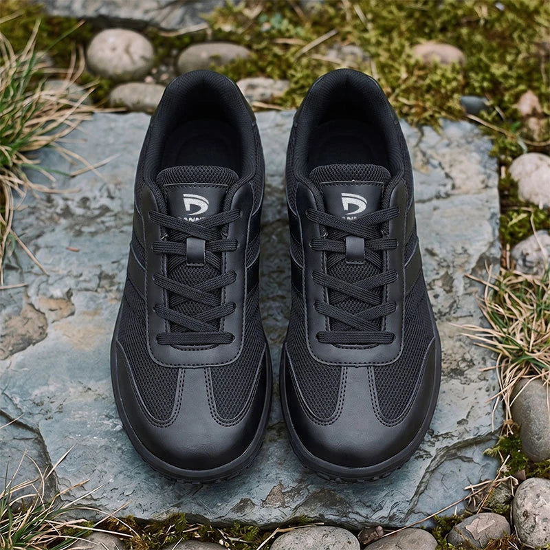 Dannto Frond - Non-Slip Zero Drop Barefoot Sneakers black pair shown from above on rocks