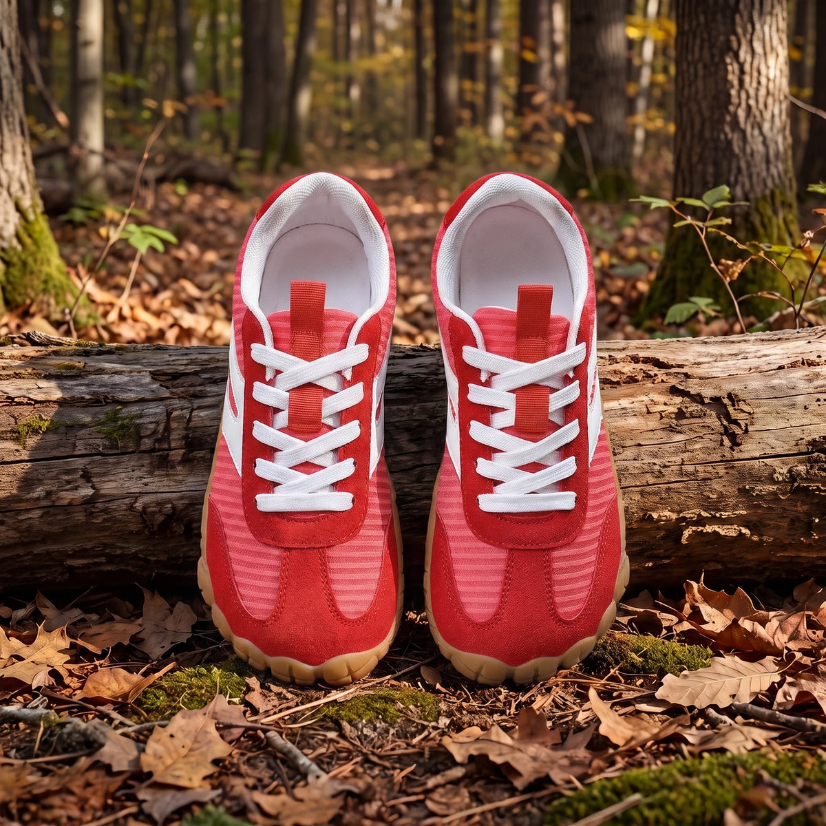 DANNTO Purus Men's and Women's Wide Toe Box Barefoot Shoes in Red Shown Side by Side on a Forest Floor in Front of a Fallen Log.
