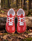 DANNTO Purus Men's and Women's Wide Toe Box Barefoot Shoes in Red Shown Side by Side on a Forest Floor in Front of a Fallen Log.