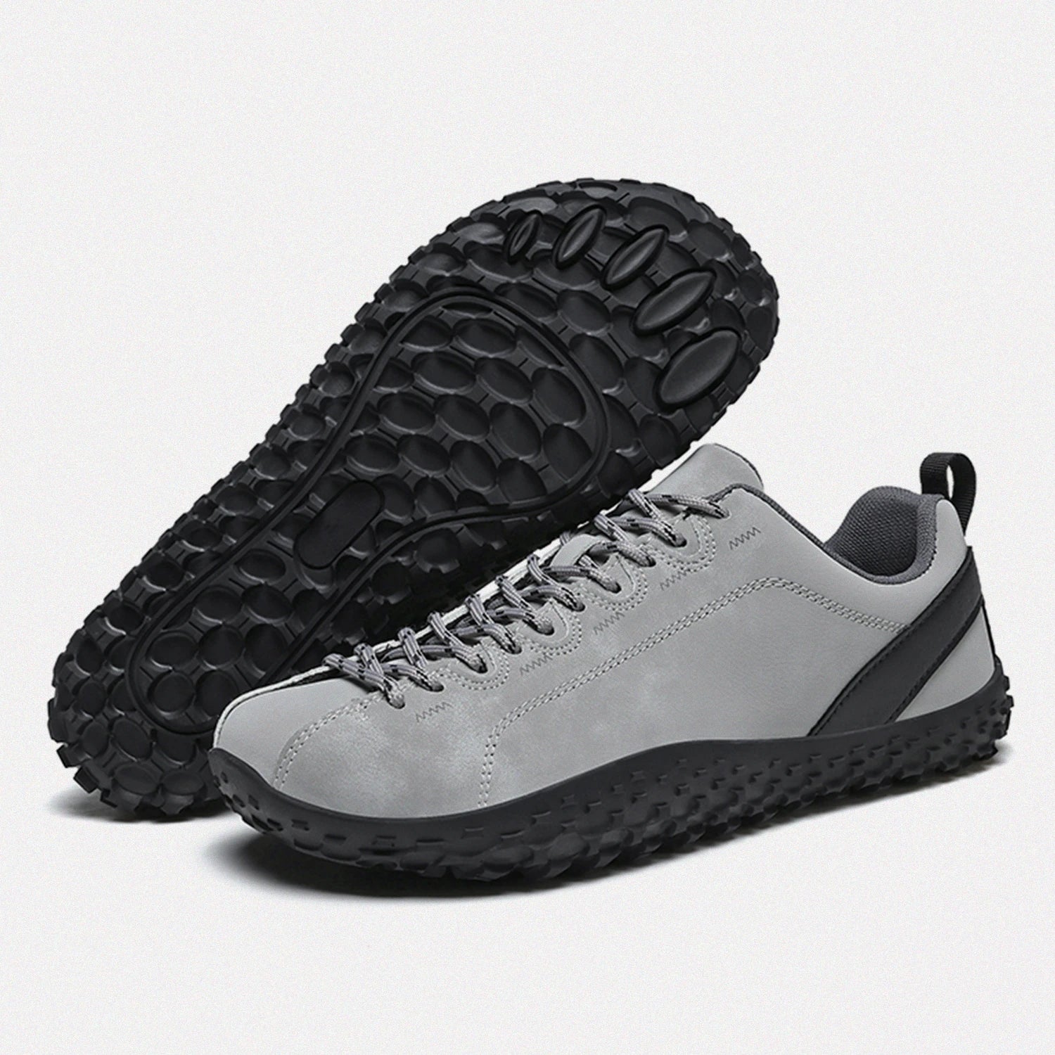 Dannto gray barefoot outdoor sneakers shown from a three quarter view and the bottom