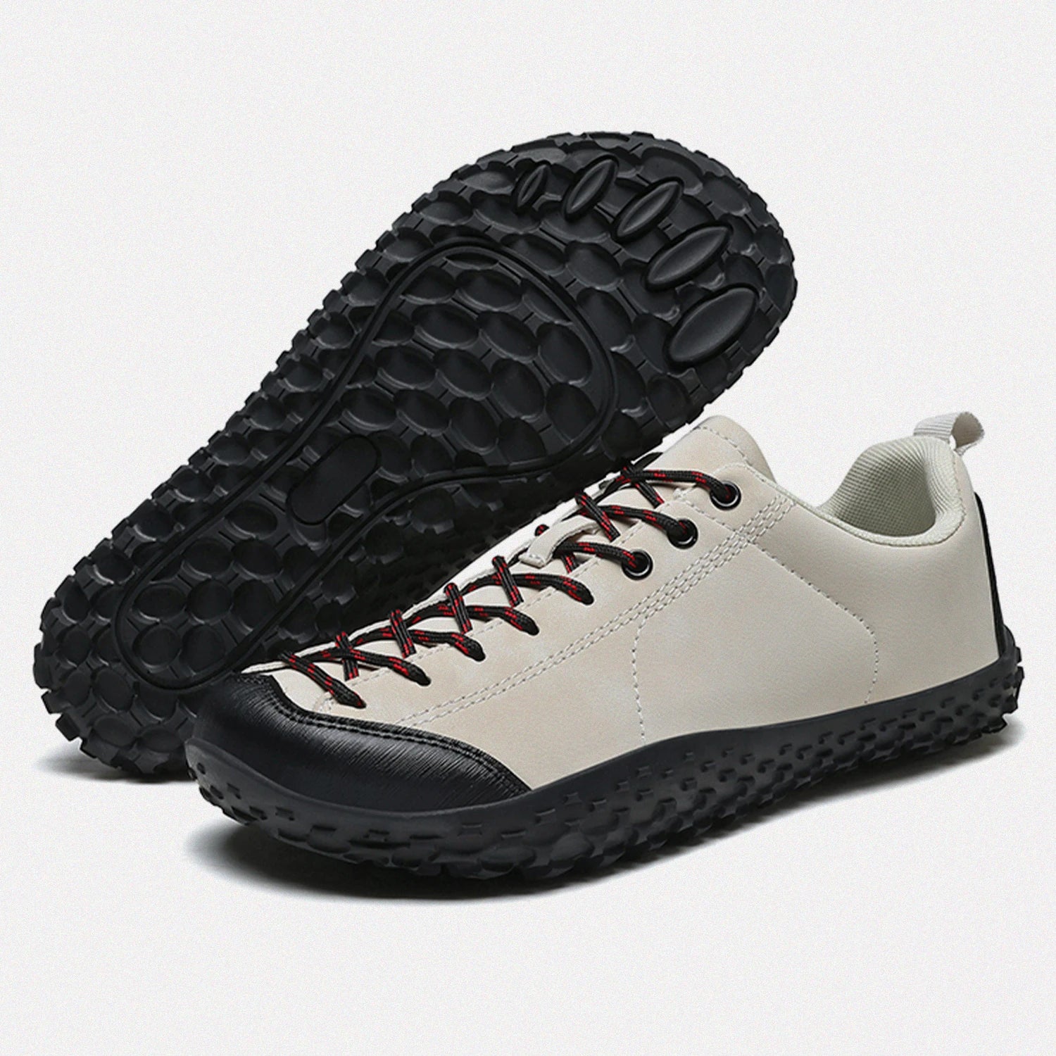 Dannto beige barefoot trail shoes shown from a three quarter view and the bottom