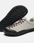 Dannto beige barefoot trail shoes shown from a three quarter view and the bottom