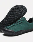 Dannto green barefoot trail shoes shown from a three quarter view and the bottom