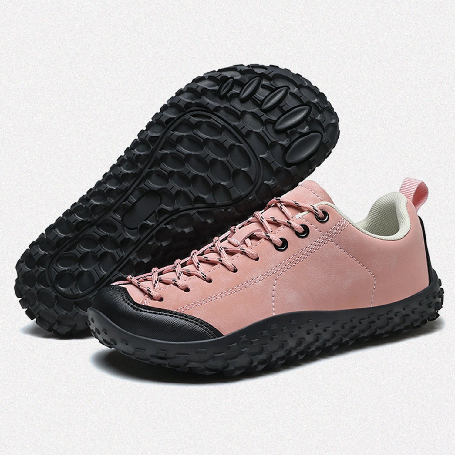 Dannto pink barefoot trail shoes shown from a three quarter view and the bottom