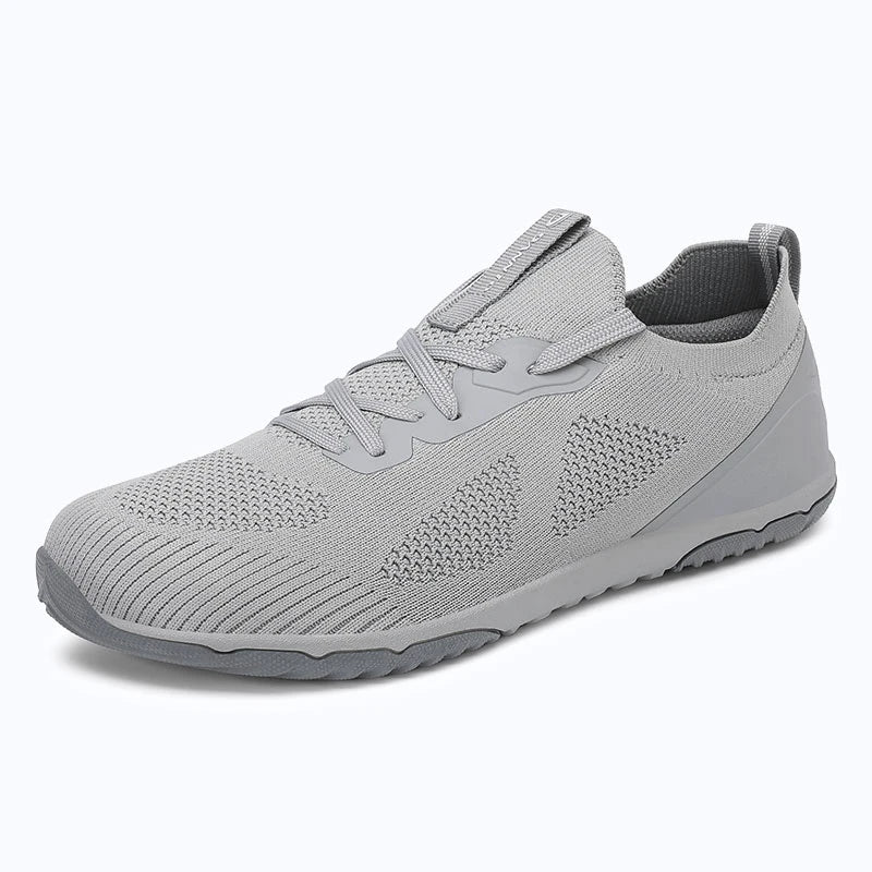 Dannto mid gray zero drop barefoot sneakers shown from a three quarter view