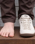 Dannto Veld I – 3E wide toe box barefoot shoes Beige, shown beside a bare foot