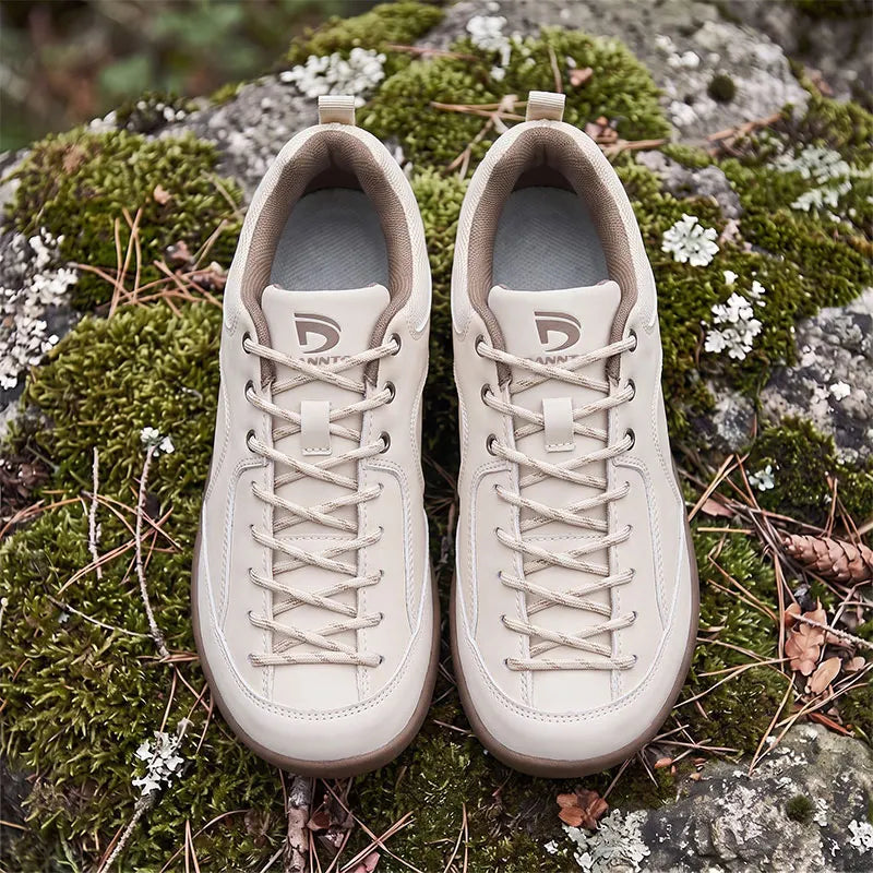 Dannto Veld I – 3E wide toe box barefoot shoes Beige, displayed on moss-covered rocks outdoors