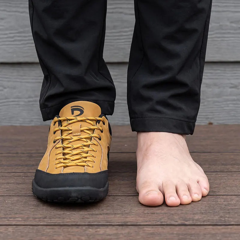 Dannto Veld I – 3E wide toe box barefoot shoes Tan, shown beside a bare foot