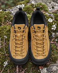 Dannto Veld I – 3E wide toe box barefoot shoes Tan, displayed on moss-covered rocks outdoors