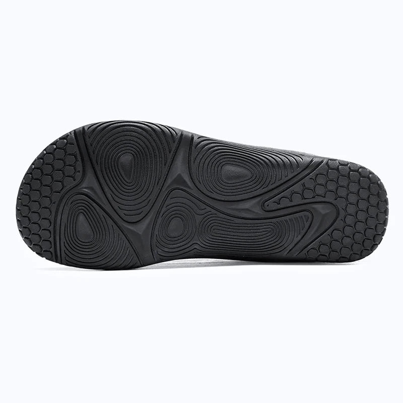 Dannto Aero N1 - 3E Wide Mesh Barefoot Shoes black shown from a bottom view, highlighting the rubber outsole