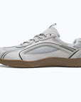 Dannto Aero N1 - 3E Wide Mesh Barefoot Shoes white shown being put on while sitting outdoors